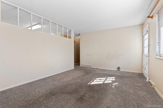 carpeted empty room with baseboards and visible vents