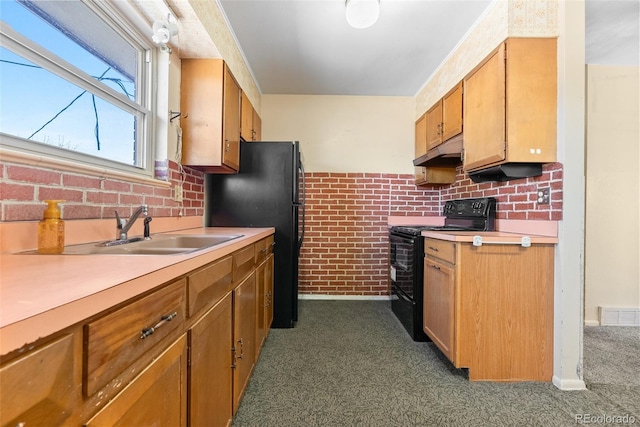 kitchen featuring light countertops, a sink, under cabinet range hood, and black appliances