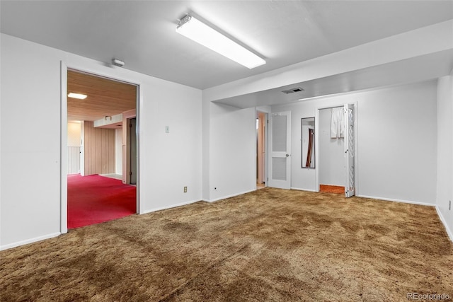 carpeted empty room featuring visible vents