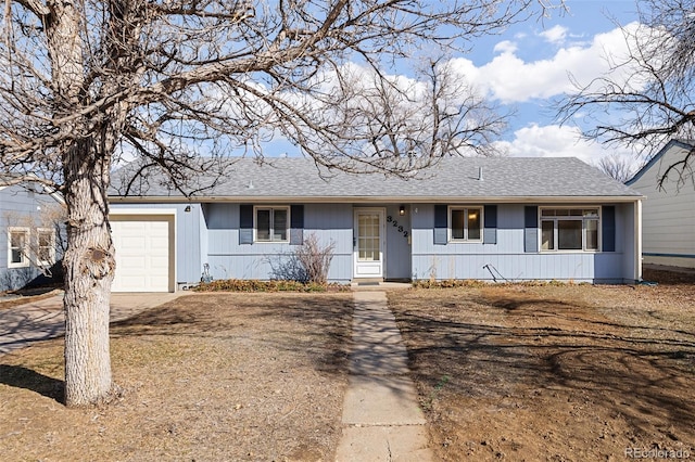 ranch-style house with a garage, driveway, and roof with shingles