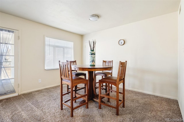 dining room with carpet floors and baseboards