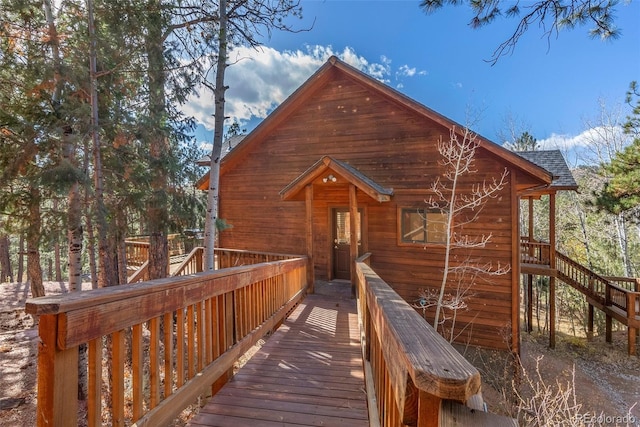 back of property featuring a wooden deck