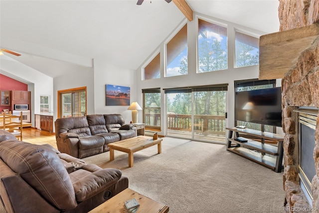 carpeted living room with beam ceiling, ceiling fan, high vaulted ceiling, and plenty of natural light