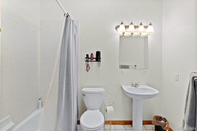 full bathroom with toilet, sink, tile patterned flooring, and shower / tub combo with curtain