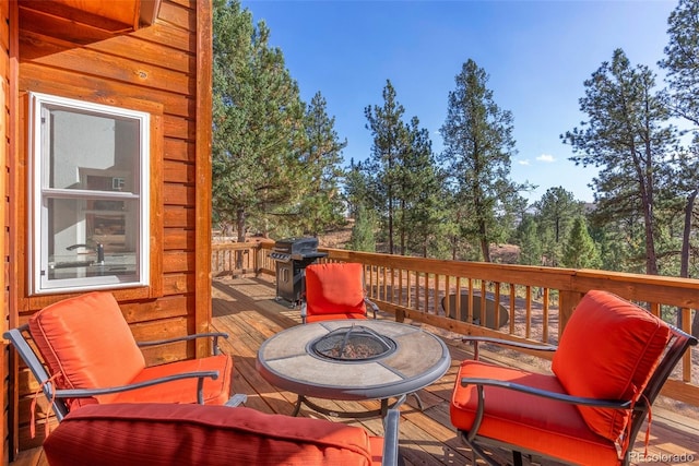 wooden terrace with a fire pit