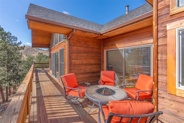 deck featuring an outdoor fire pit and a mountain view