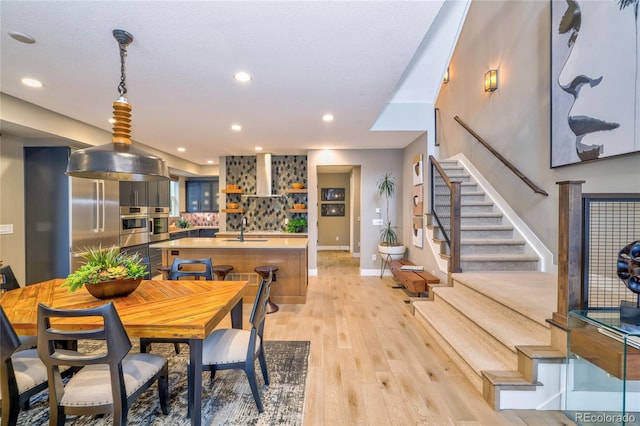 dining area with light hardwood / wood-style floors and sink