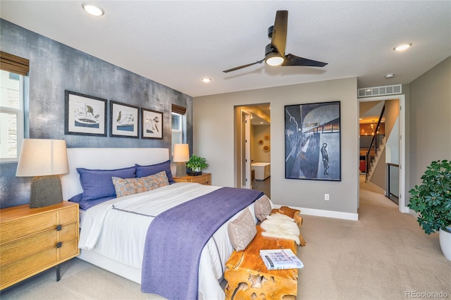 carpeted bedroom with connected bathroom and ceiling fan