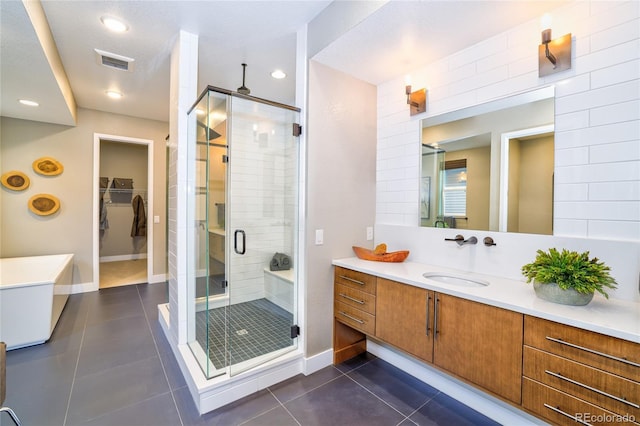 bathroom with vanity, tile patterned floors, and a shower with door