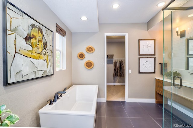 bathroom featuring tile patterned flooring, vanity, and shower with separate bathtub