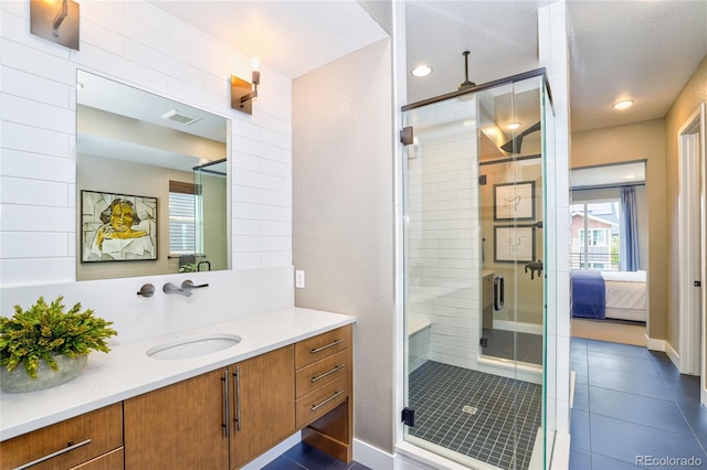 bathroom featuring vanity and a shower with shower door