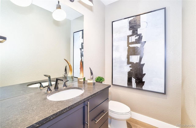 bathroom featuring vanity and toilet