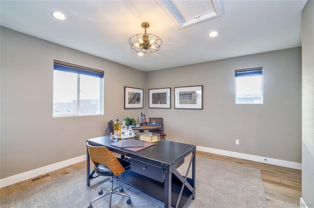 office area with light hardwood / wood-style flooring and plenty of natural light