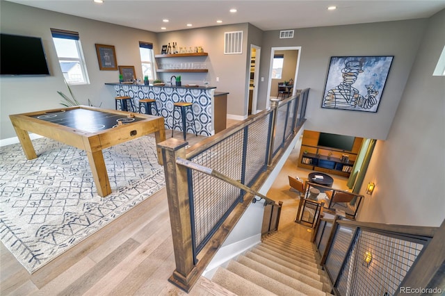 playroom featuring indoor wet bar and light hardwood / wood-style flooring