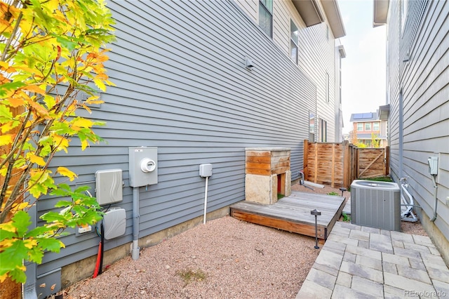 view of side of property with cooling unit and a deck