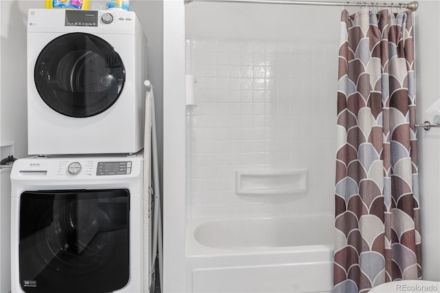 clothes washing area with stacked washer / dryer and laundry area