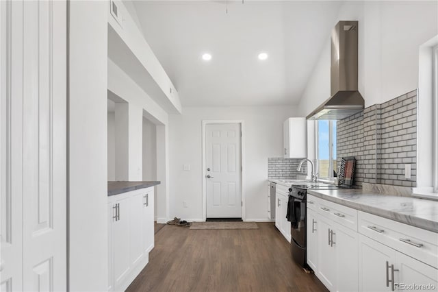 kitchen with electric range, dark wood finished floors, decorative backsplash, wall chimney range hood, and white cabinetry