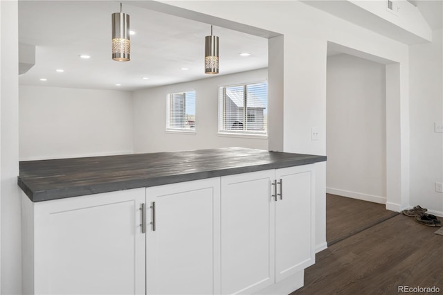 kitchen with recessed lighting, white cabinetry, dark wood finished floors, and wooden counters