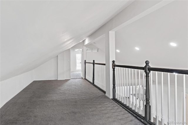 interior space featuring carpet and vaulted ceiling