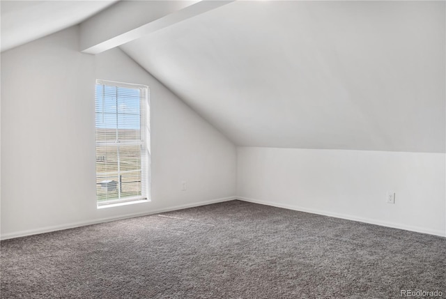 bonus room featuring lofted ceiling with beams, carpet, baseboards, and a healthy amount of sunlight