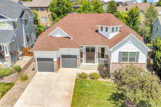 2142 Paint Pony Cir, Castle Rock, CO 80108 - view of front of property featuring brick siding, a garage, concrete driveway, and a shingled roof