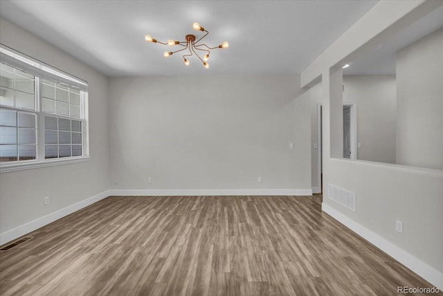 2142 Paint Pony Cir, Castle Rock, CO 80108 - unfurnished room with a chandelier and wood finished floors