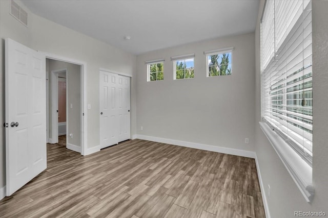 2142 Paint Pony Cir, Castle Rock, CO 80108 - unfurnished bedroom with light wood finished floors and a closet