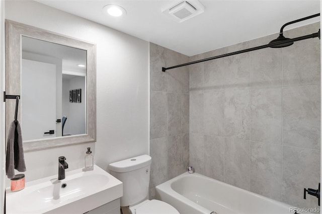 full bathroom featuring vanity, toilet, and tiled shower / bath