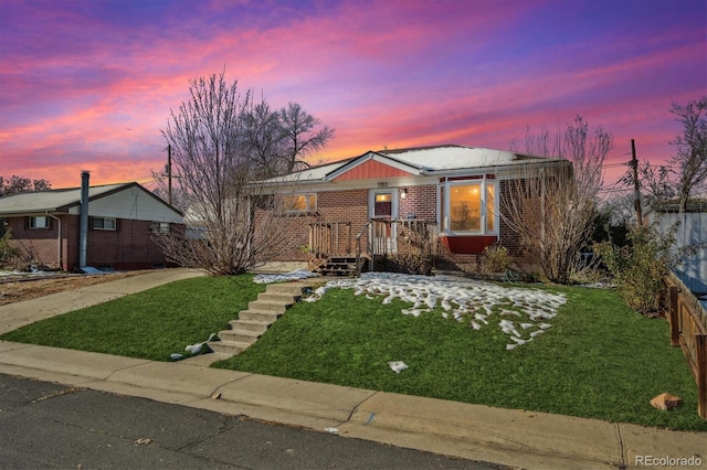 single story home with a lawn