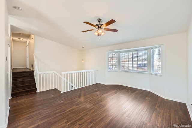 spare room featuring ceiling fan and dark hardwood / wood-style floors