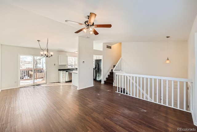 unfurnished living room featuring ceiling fan with notable chandelier, lofted ceiling, and hardwood / wood-style flooring