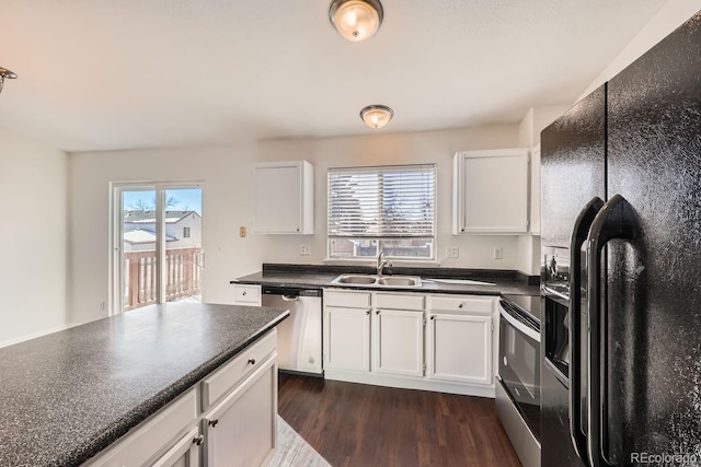 kitchen featuring stainless steel appliances, white cabinetry, sink, and dark hardwood / wood-style floors