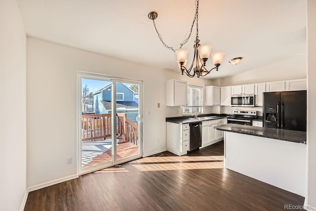 kitchen with pendant lighting, a notable chandelier, white cabinetry, appliances with stainless steel finishes, and sink