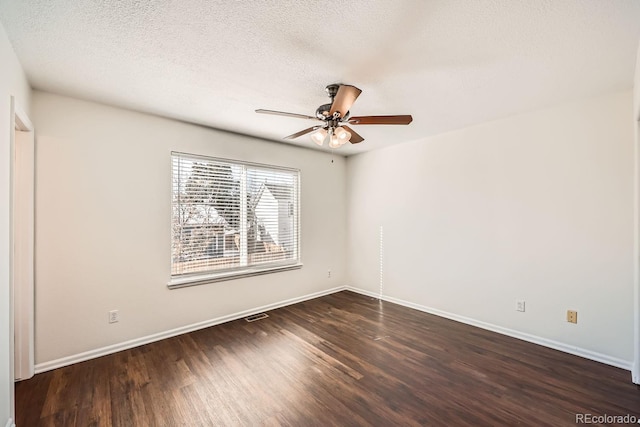 spare room with ceiling fan, dark wood-type flooring, and a textured ceiling