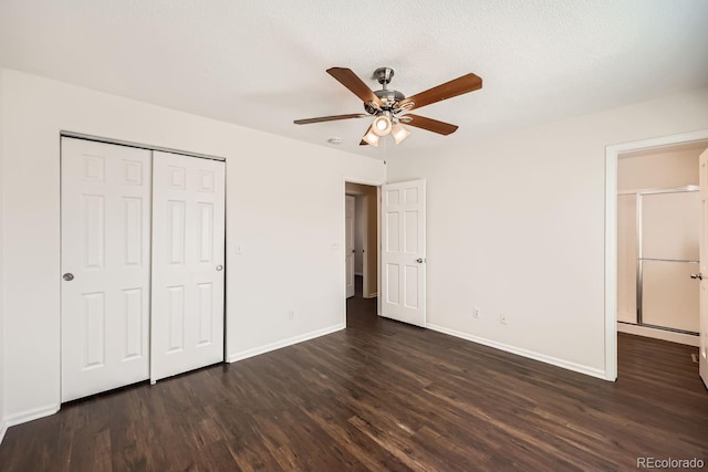 unfurnished bedroom featuring a closet, ceiling fan, a textured ceiling, and dark wood-type flooring