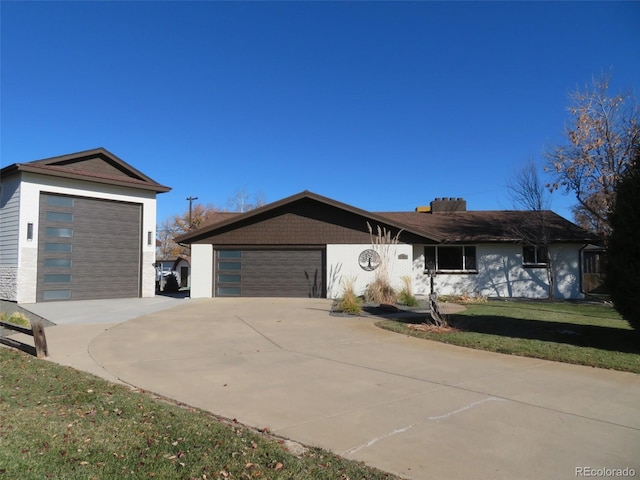 view of front of house with a garage and a front lawn