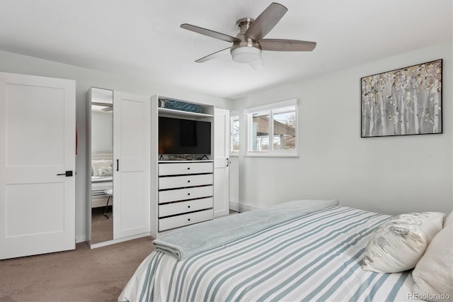 bedroom with ceiling fan, light carpet, and ensuite bath