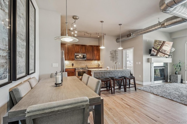 10111 Inverness Main St Unit 230, Englewood, CO 80112 - dining space with light wood-style floors