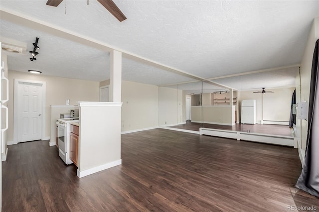 unfurnished living room featuring a baseboard heating unit, dark hardwood / wood-style floors, a textured ceiling, and ceiling fan