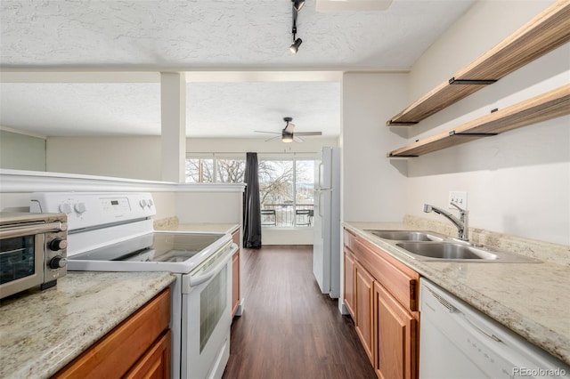 kitchen with sink, light stone counters, a textured ceiling, dark hardwood / wood-style flooring, and white appliances