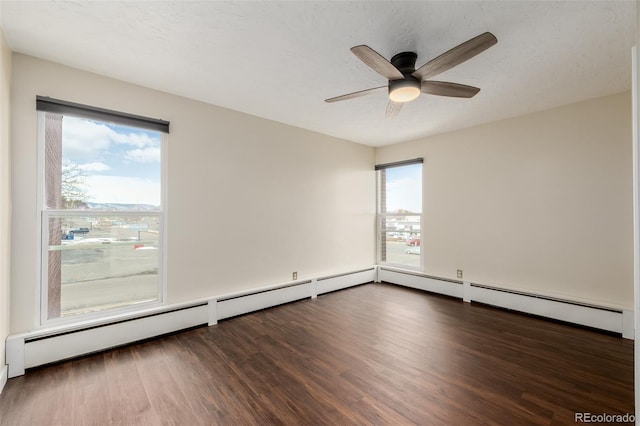 empty room with a textured ceiling, dark wood-type flooring, and ceiling fan