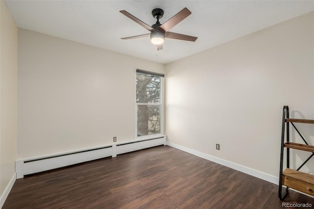 spare room featuring dark wood-type flooring, a baseboard radiator, and ceiling fan