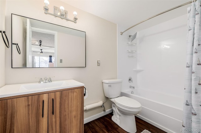 full bathroom featuring vanity, hardwood / wood-style flooring, shower / bath combo, and toilet