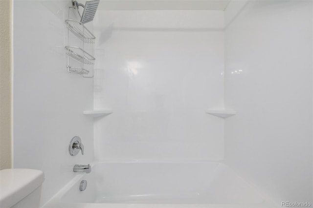 bathroom with bathtub / shower combination and toilet