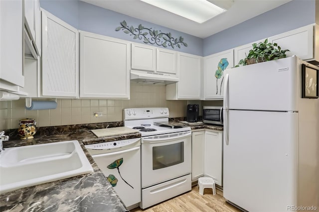 kitchen with sink, white appliances, light hardwood / wood-style flooring, white cabinetry, and decorative backsplash