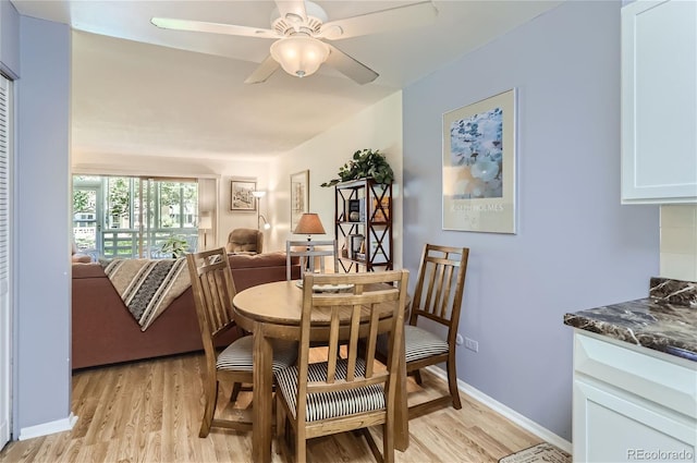 dining room with ceiling fan and light hardwood / wood-style flooring