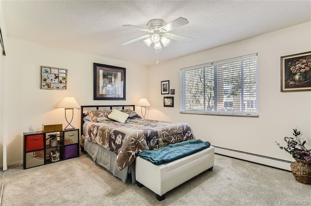 bedroom featuring baseboard heating, light colored carpet, ceiling fan, and a textured ceiling