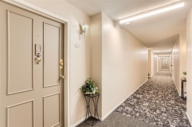 interior space featuring a textured ceiling and carpet