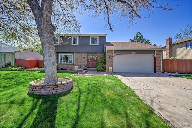 view of front of property featuring brick siding, a front lawn, an attached garage, and fence