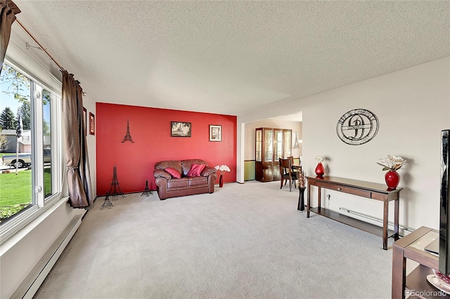 living room with carpet floors, a baseboard radiator, and a textured ceiling